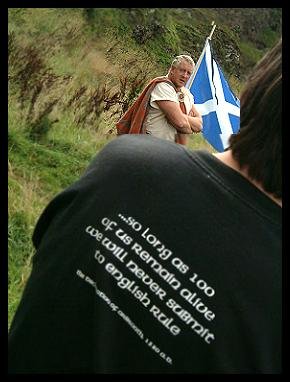 A serendipitous shot at Stonehaven Wallace Day, 27th August 2004 (taken by Mirza)- author flanked by the Saltire and an extract from the Declaration of Arbroath